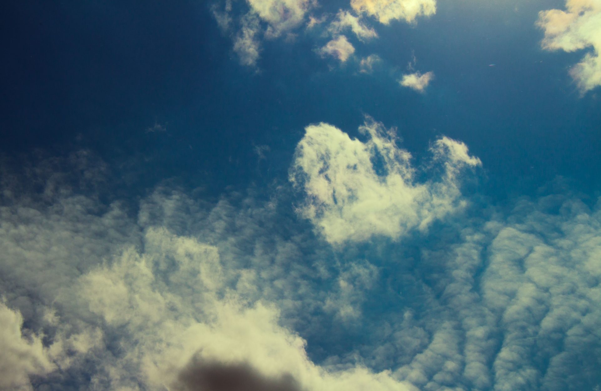 Clouds breaking across a deep blue sky