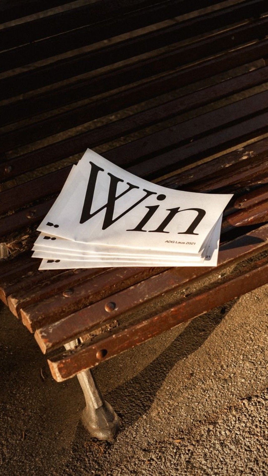 A stack of printed reports on a bench